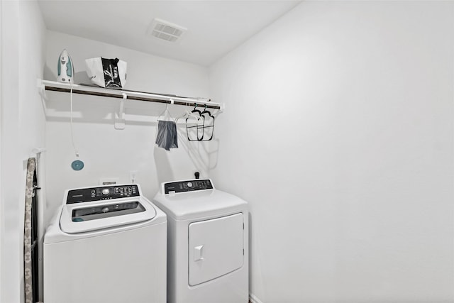 laundry room with visible vents, laundry area, and washing machine and clothes dryer