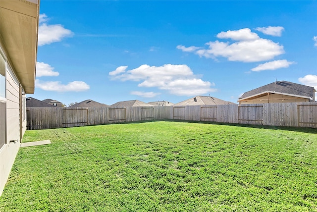 view of yard with a fenced backyard