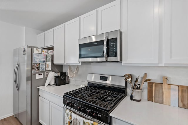 kitchen featuring white cabinetry, light hardwood / wood-style flooring, and stainless steel appliances