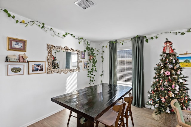 dining space featuring light wood-type flooring