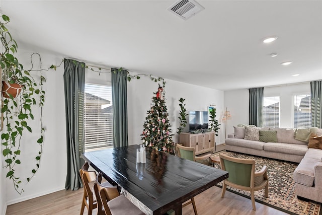 dining space with light hardwood / wood-style flooring