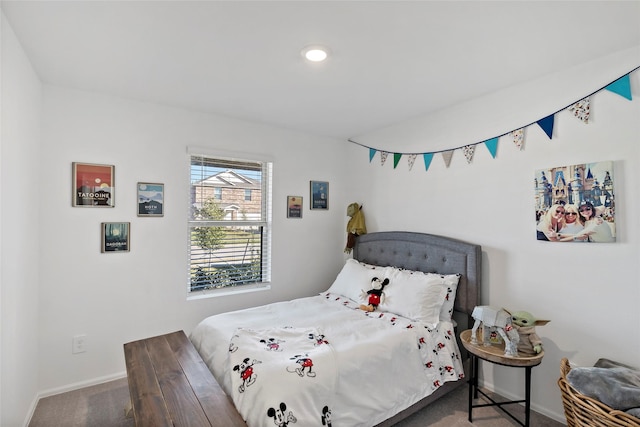 bedroom featuring baseboards and carpet