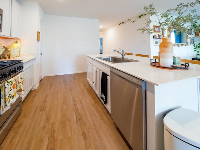 kitchen featuring white cabinets, appliances with stainless steel finishes, and a sink