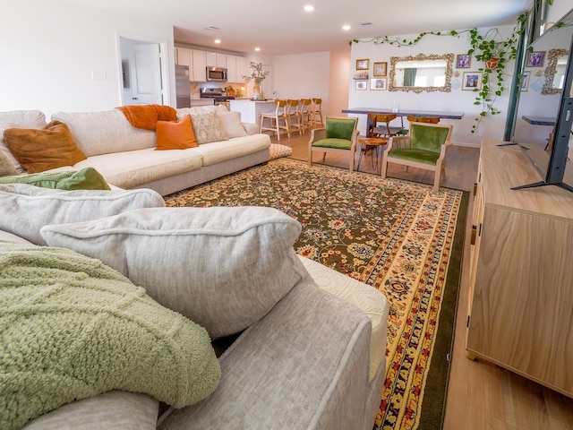 living room with recessed lighting and wood finished floors