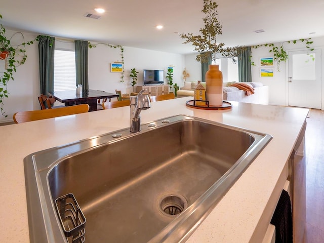 details with a sink, visible vents, recessed lighting, and light countertops