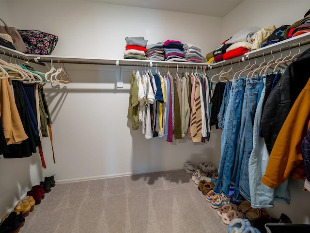 walk in closet with carpet