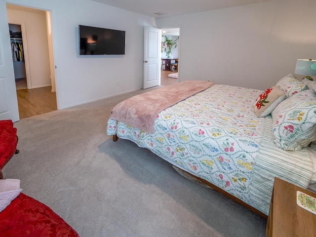 bedroom featuring a spacious closet and carpet flooring