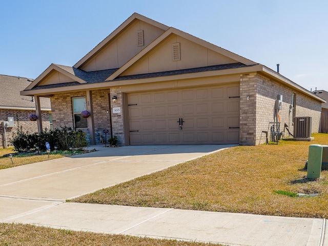 ranch-style home with cooling unit, concrete driveway, a front yard, a garage, and brick siding