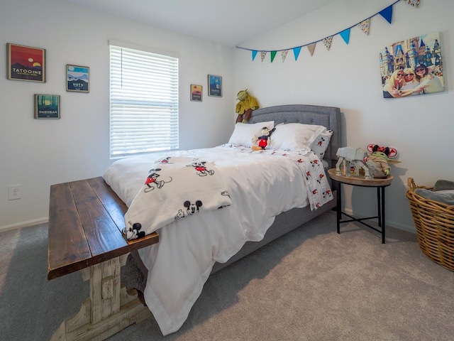 carpeted bedroom with vaulted ceiling and baseboards