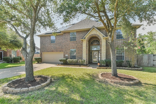 view of front of house featuring a garage and a front yard