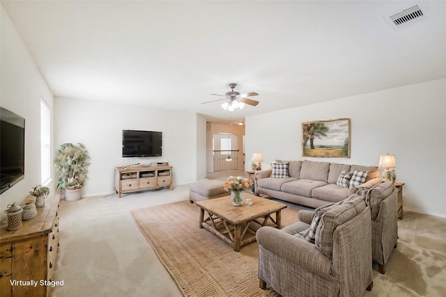 carpeted living room with ceiling fan