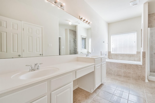 bathroom with tile patterned flooring, vanity, and separate shower and tub