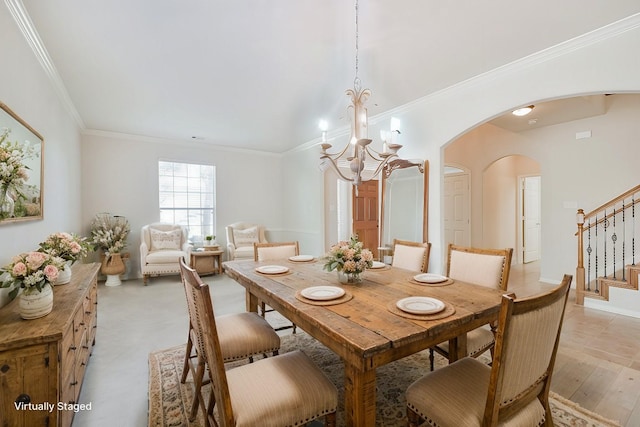 dining area featuring crown molding and a notable chandelier