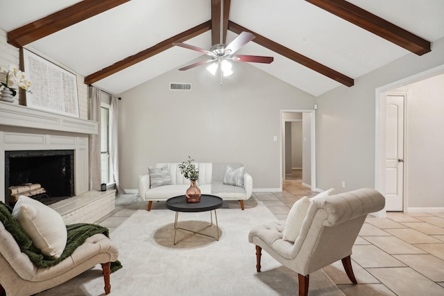 tiled living room with ceiling fan, beam ceiling, high vaulted ceiling, and a brick fireplace