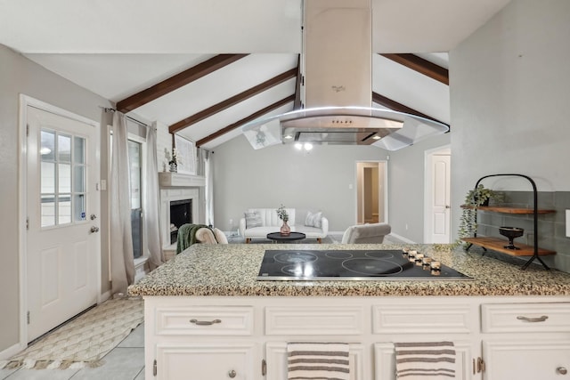 kitchen with vaulted ceiling with beams, white cabinetry, black electric cooktop, and light stone counters