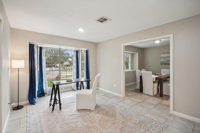 tiled dining room featuring plenty of natural light