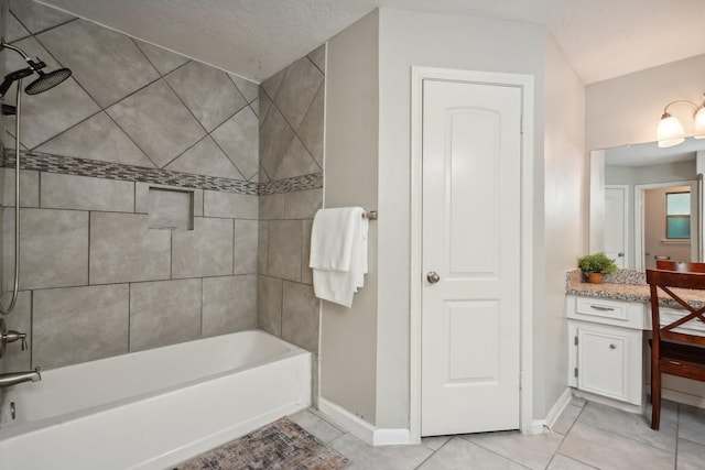 bathroom with tile patterned flooring, vanity, tiled shower / bath combo, and a textured ceiling