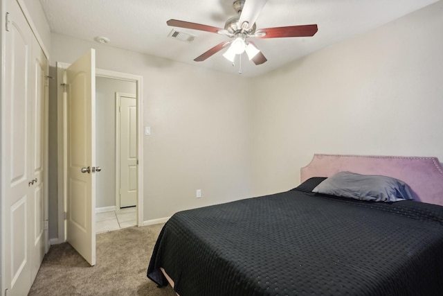 bedroom featuring ceiling fan and light carpet