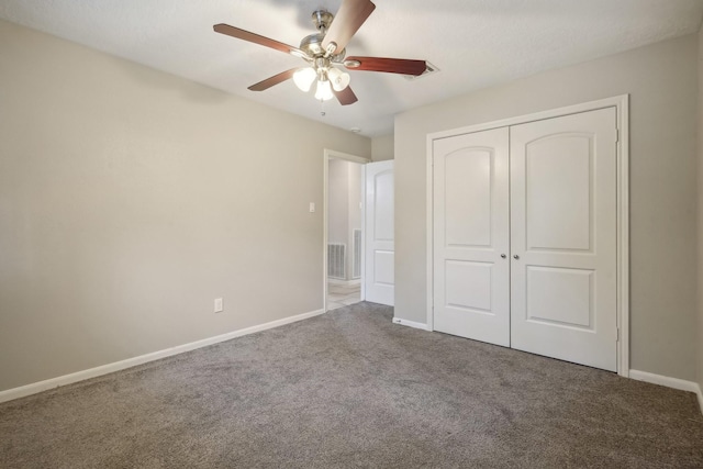 unfurnished bedroom featuring carpet, ceiling fan, and a closet