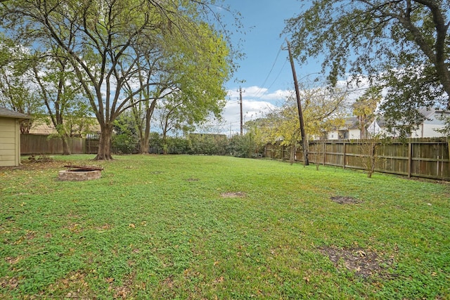 view of yard with a fire pit