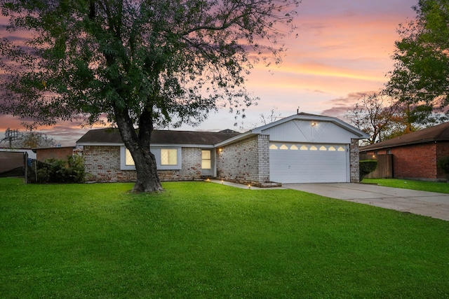 ranch-style home featuring a garage and a yard