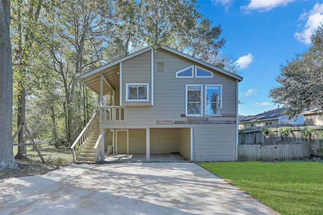 rear view of house featuring a yard