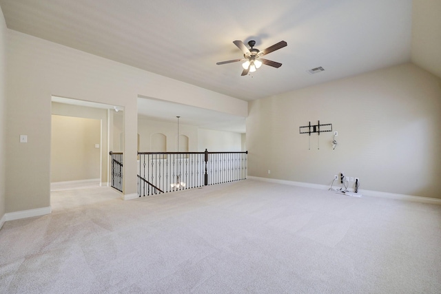 empty room with ceiling fan, light colored carpet, and lofted ceiling