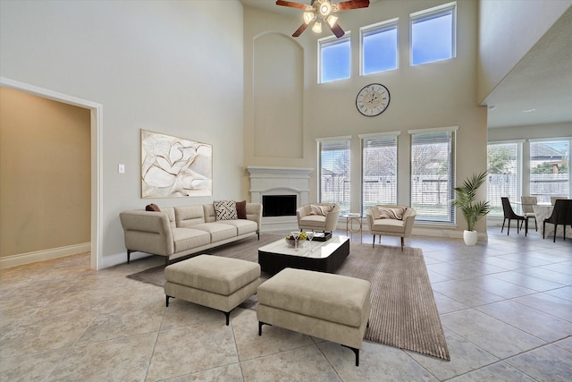 tiled living room featuring a towering ceiling and ceiling fan