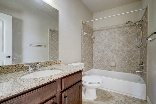 full bathroom featuring tile patterned flooring, vanity, toilet, and tiled shower / bath