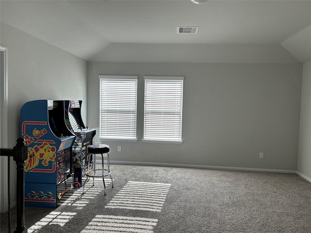 interior space with carpet and vaulted ceiling