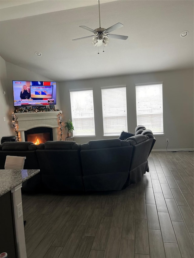 living room with ceiling fan and vaulted ceiling