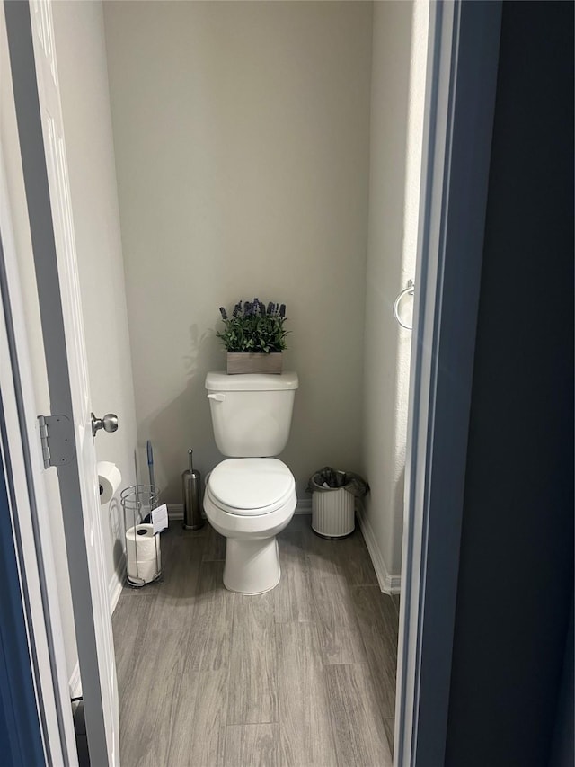 bathroom with hardwood / wood-style floors and toilet