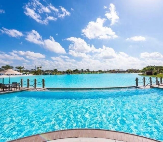 view of pool with a water view