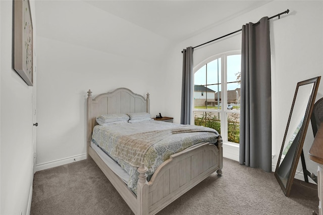 carpeted bedroom with multiple windows and lofted ceiling