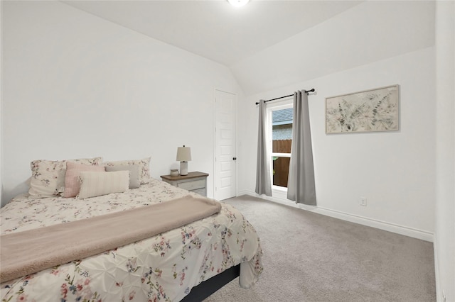 bedroom with light colored carpet and vaulted ceiling