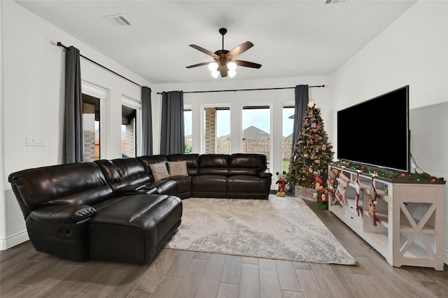 living room with hardwood / wood-style floors and ceiling fan