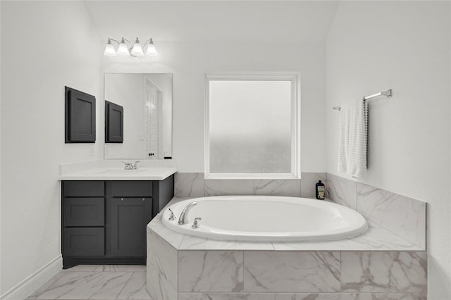 bathroom with vanity and tiled tub