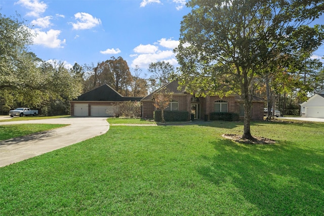 view of front of home with a front yard and a garage