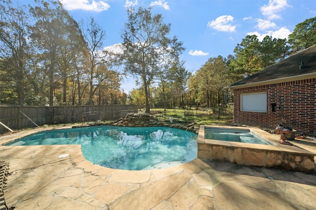 view of pool with a patio area and an in ground hot tub