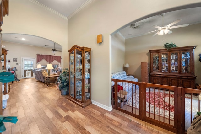 interior space with light wood-type flooring and ornamental molding