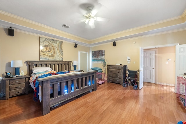 bedroom with hardwood / wood-style flooring, ceiling fan, and crown molding