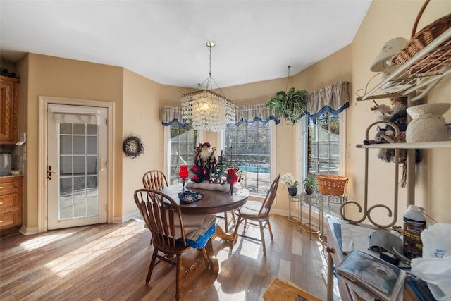 dining room with a notable chandelier and wood-type flooring