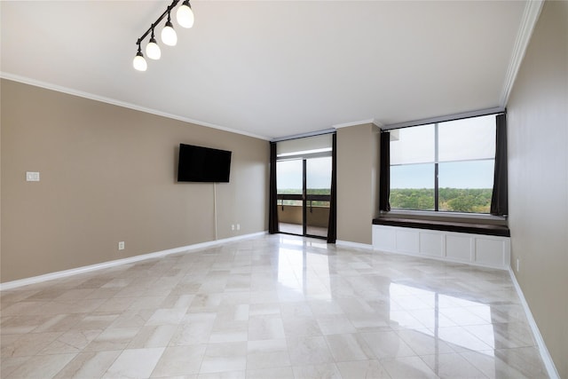 spare room featuring light tile patterned floors and crown molding