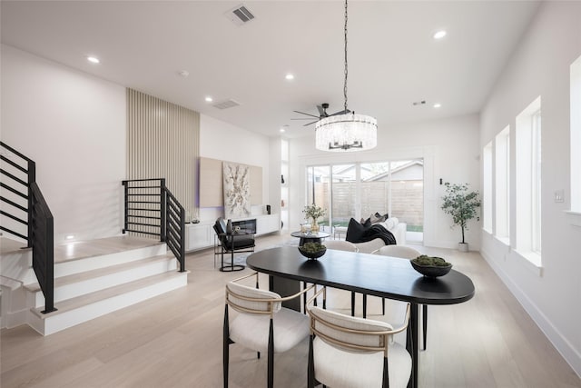 dining room featuring a wealth of natural light, a notable chandelier, and light hardwood / wood-style flooring