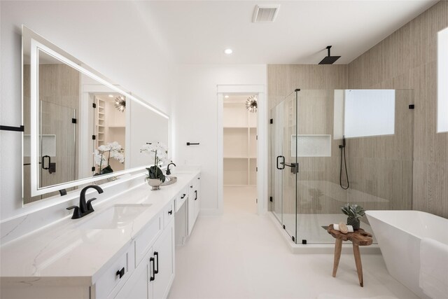 bathroom featuring shower with separate bathtub and vanity