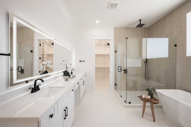 bathroom with vanity and independent shower and bath