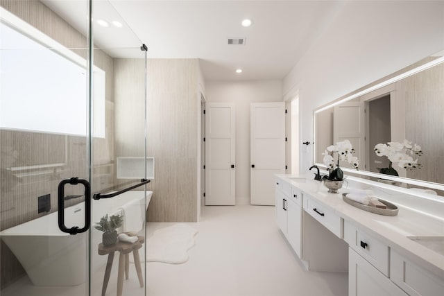 bathroom featuring concrete flooring, vanity, and a bathtub