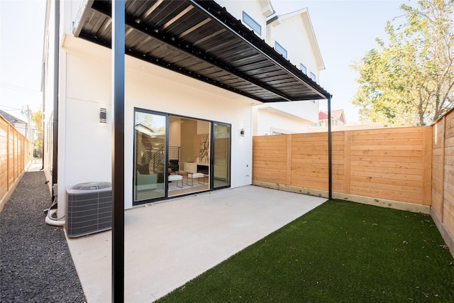 back of property featuring central AC unit and a patio