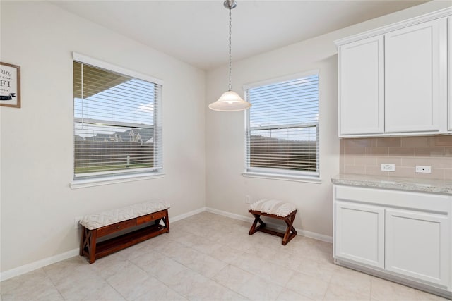 dining space with a wealth of natural light and baseboards