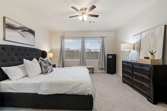 bedroom with a ceiling fan, light colored carpet, visible vents, and baseboards